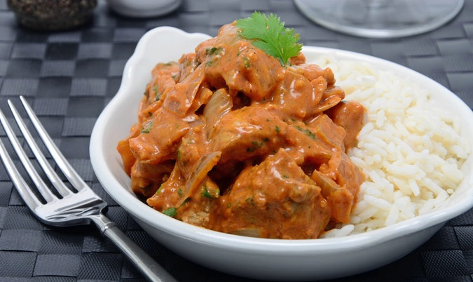 lamb tikka masala with rice and can of drink